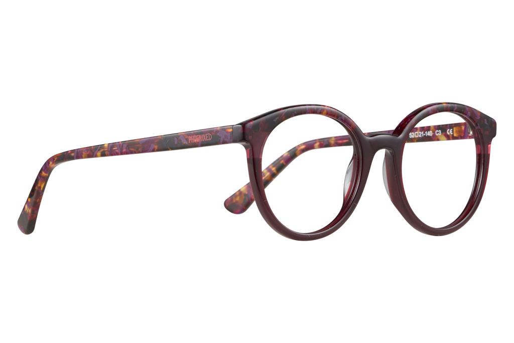 Purple round eyeglasses with colorful patterned temples laid flat on a gray background.