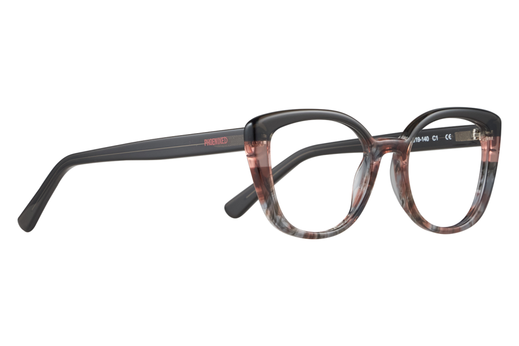 Close-up of fashion eyeglasses with a dark tortoiseshell frame and black temples on a light surface