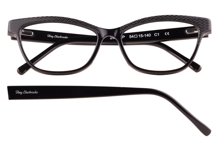 Black plastic eyeglasses with a textured zigzag pattern on the frame and Amy Sherbrooke branding on the armanel