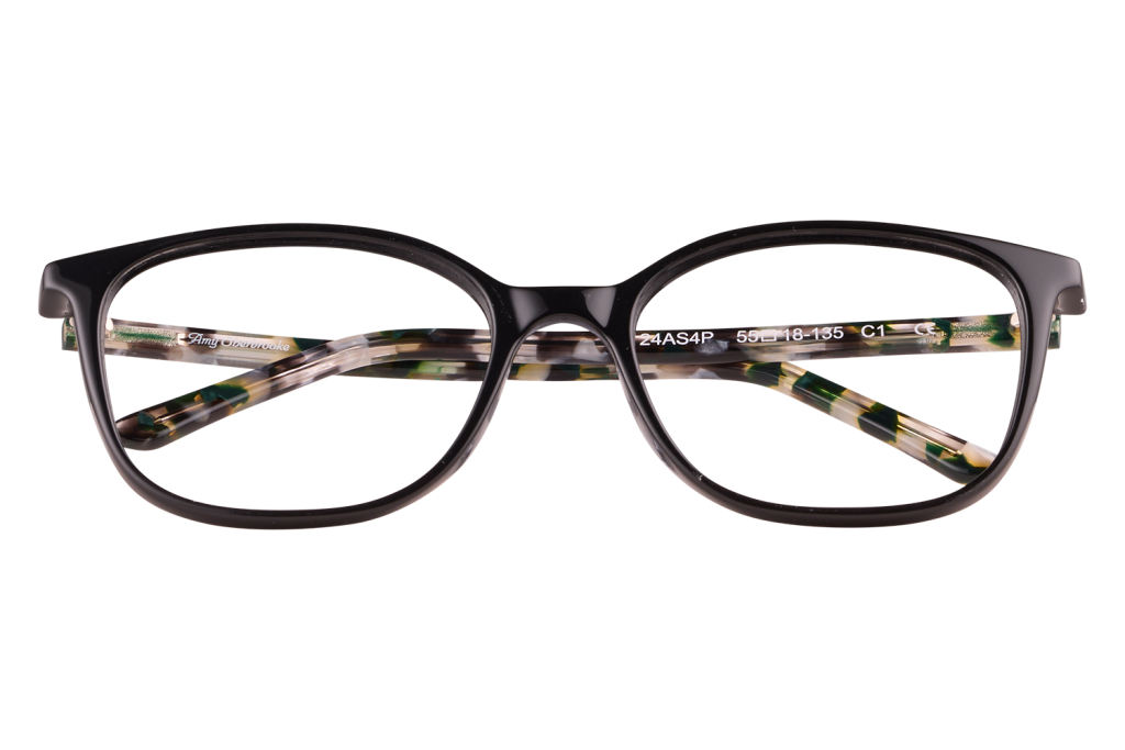 Black plastic eyeglasses with tortoiseshell-patterned temples resting on a clear block.