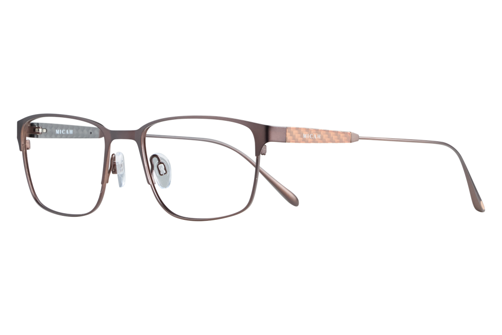 Brown rectangular eyeglasses with clear nose pads and copper-patterned temples resting on a gray background, brand Micah visible on the arm.