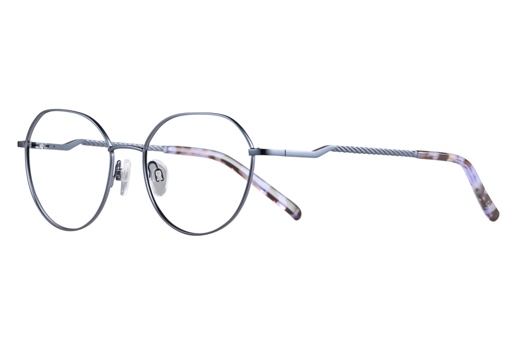 Close-up of round metal eyeglasses with clear nose pads and twisted temples on a neutral surface.