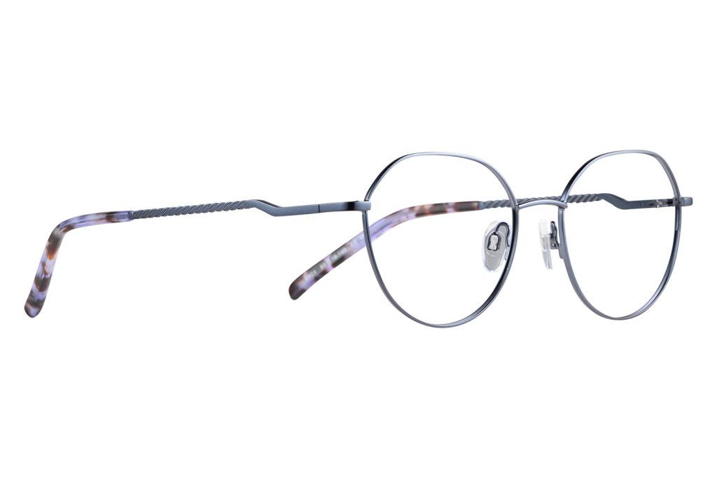 Round metal eyeglasses with tortoiseshell-accented temples resting on a light surface.