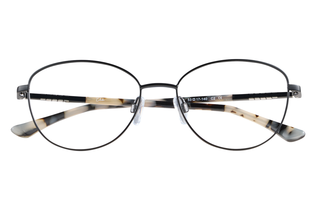 Round metal-frame eyeglasses with tortoiseshell temples perched on a clear display stand, showing model numbers along the arm.