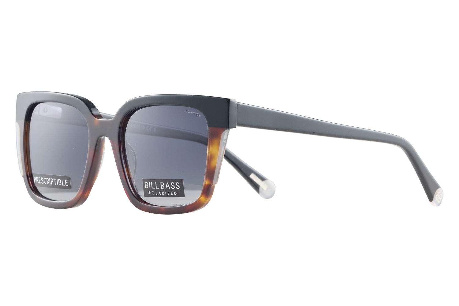 Pair of thick-framed sunglasses with grey gradient lenses; labels on the lenses read 'PRESCRIPTIBLE' and 'BILLBASS POLARISED'.