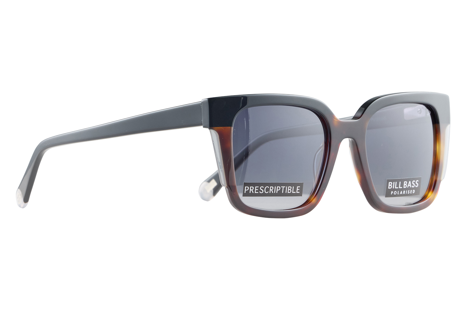 Tortoiseshell sunglasses with dark rectangular lenses and label stickers reading 'PRESCRIPTIBLE' and 'BILL BASS POLARISED'.