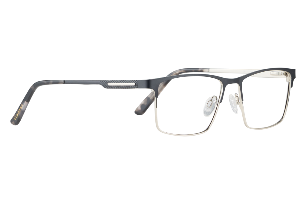 Black rectangular eyeglasses with a dark frame lying on a light surface.