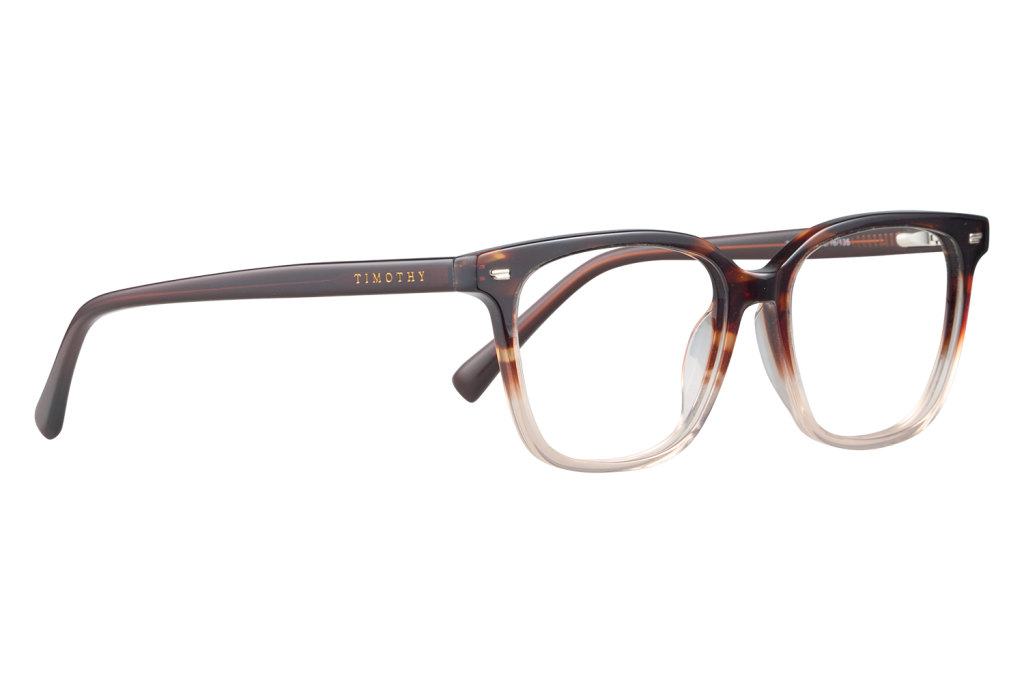 Tortoiseshell eyeglasses with gold TIMOTHY branding on the temple, close-up on a white surface.