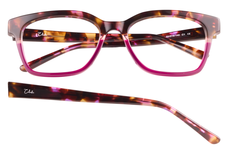 Tortoiseshell eyeglasses with pink frames and matching temple pieces laid apart, stylish chunky design with a signature on the arm.