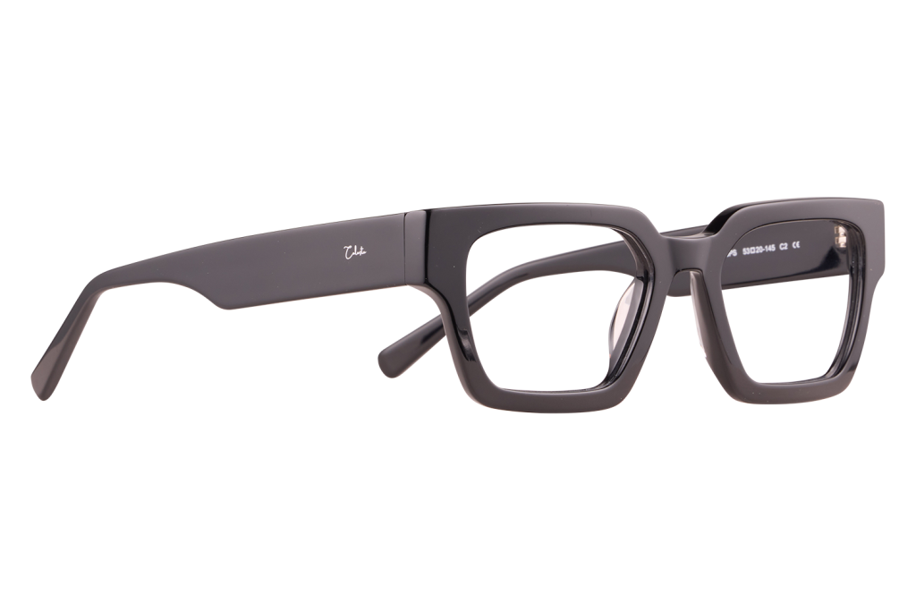 Black thick-square eyeglasses with a glossy finish, resting on a light surface; small white brand logo on the temple.