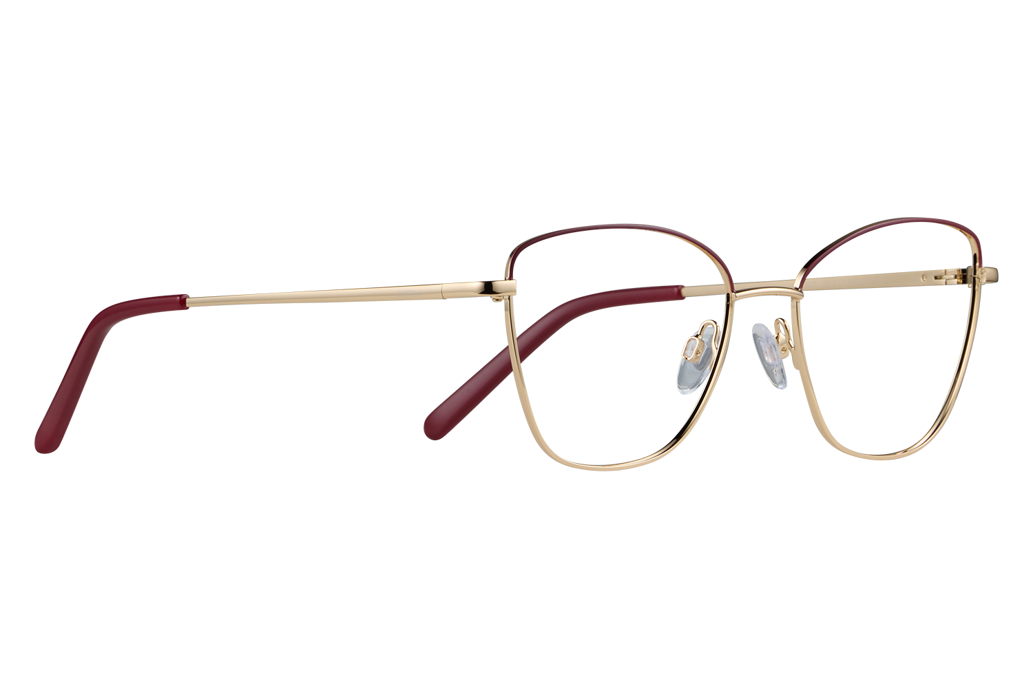 Gold pair of eyeglasses with red temple tips laid flat on a gray surface