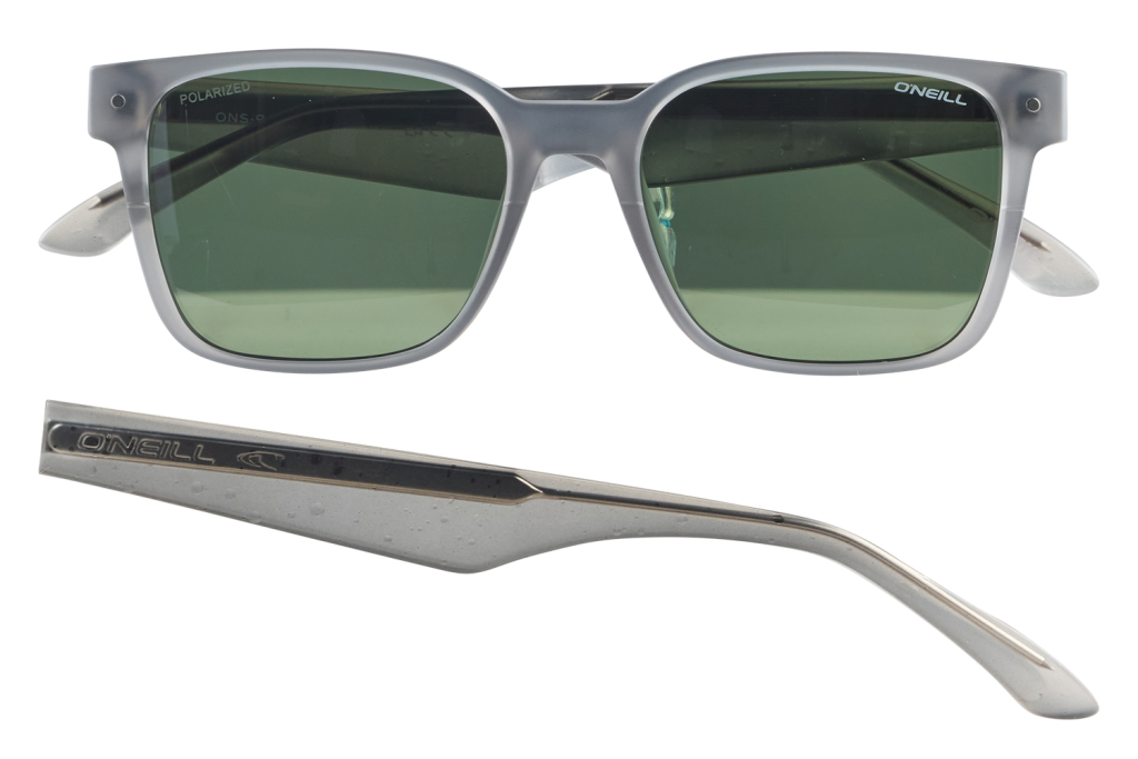 Gray-framed sunglasses with green lenses, O'Neill branding visible on the front and temple (one arm detached).