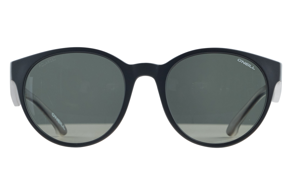 Black rounded sunglasses with dark grey lenses resting on a white surface; O'Neill branding on the temples.